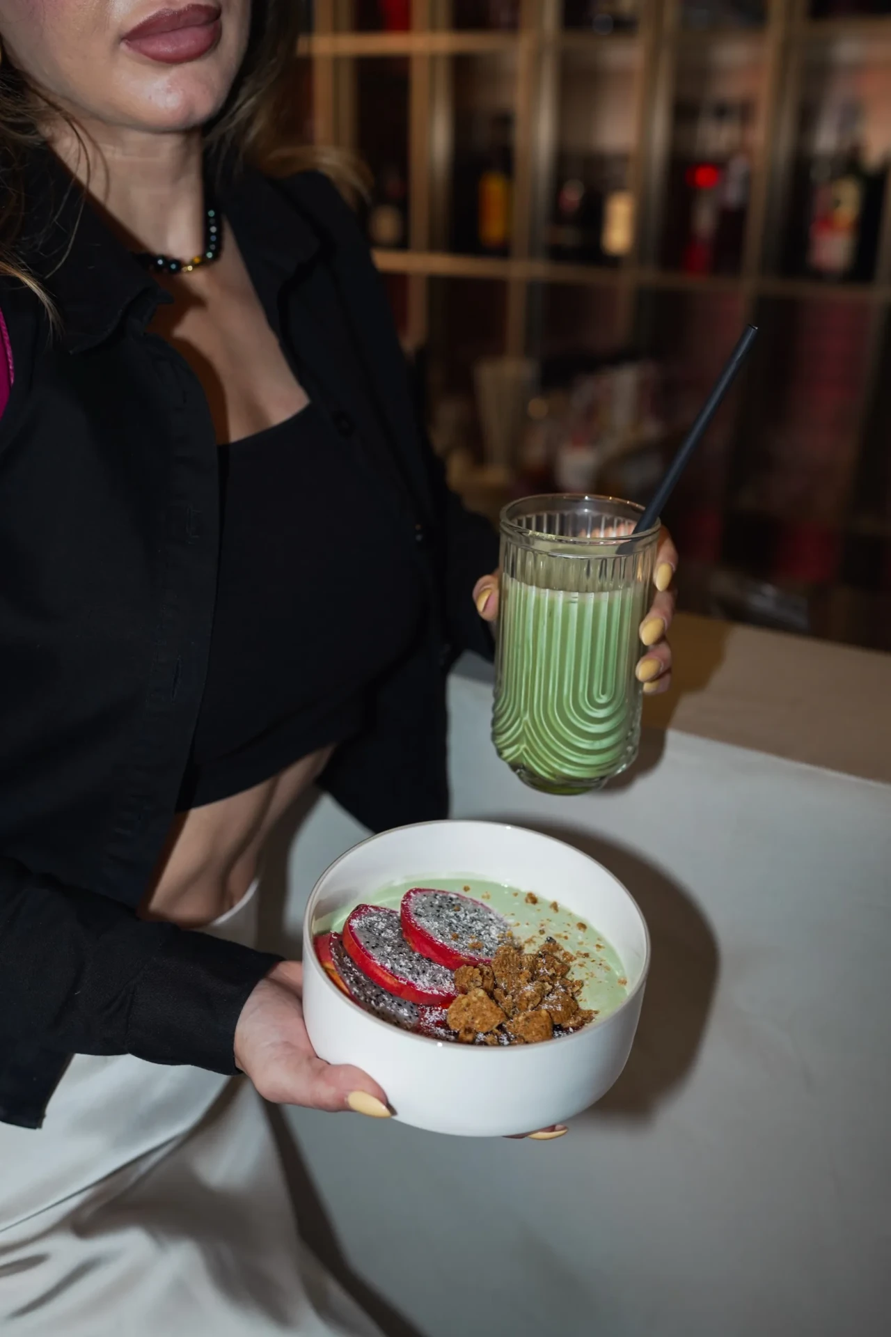 Hospitality lifestyle photograph with a green drink and breakfast bowl
