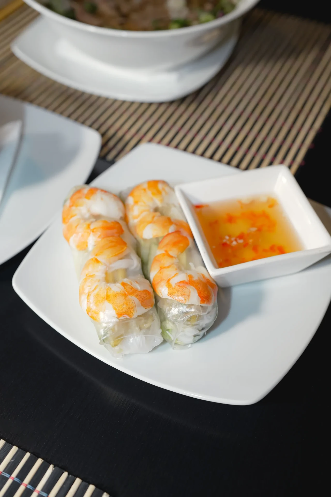 Food photography of fresh shrimp spring rolls with dipping sauce